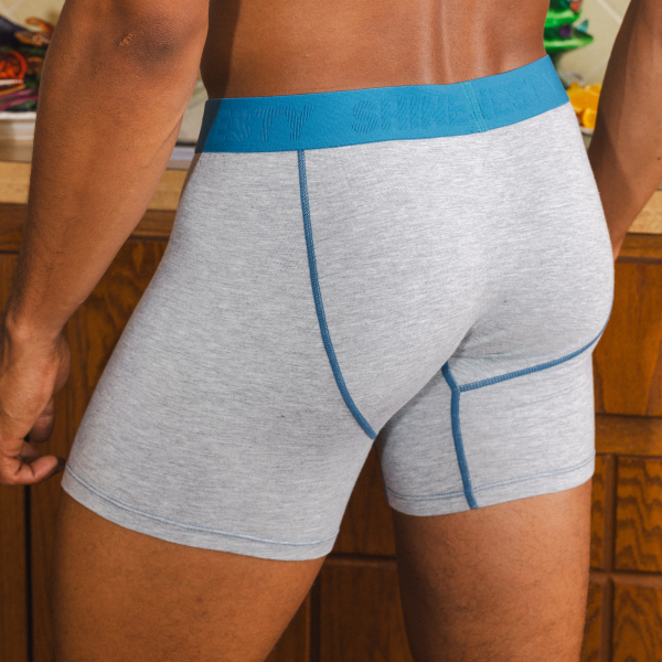 Heather gray Shinesty boxer briefs from behind, blue contrast stitching and a 6-inch inseam that ends mid-thigh
