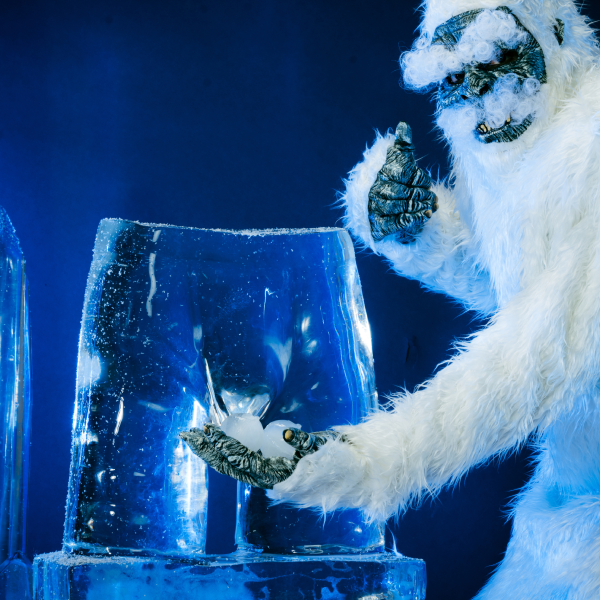 Yeti clutching a block of ice with a pair of boxer briefs frozen inside, under blue light