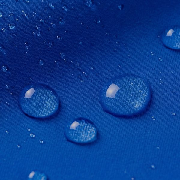 Round water droplets sitting on top of royal blue paradICE cooling fabric rather than soaking in