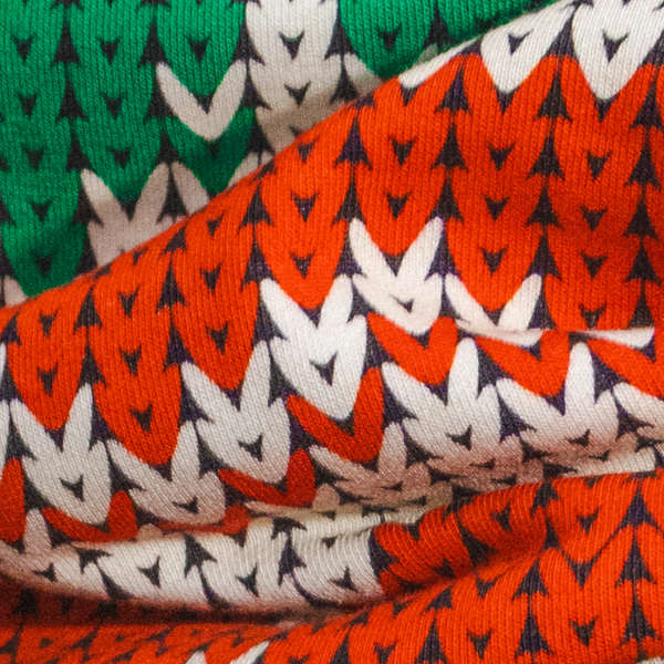 Bunched folds of the red, green and white knit-look holiday print used for Shinesty men's pajamaralls