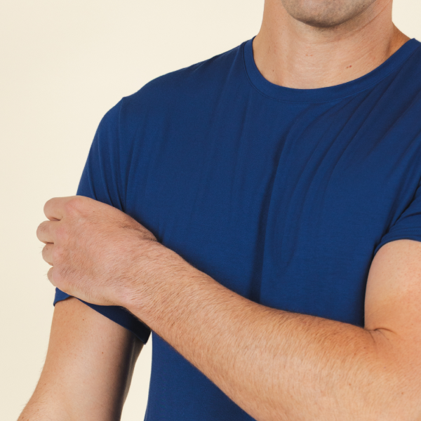 Shoulder and sleeve of a royal blue short-sleeve pajama tee, flat seams along the arm