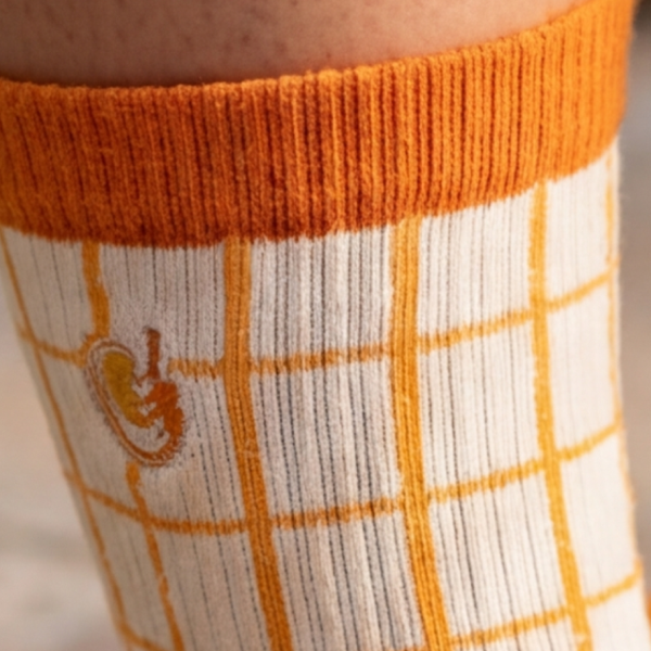 Orange windowpane-check quarter sock cuff with a tiny embroidered cocktail, ribbed and up close