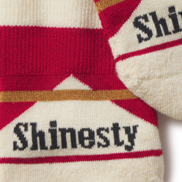 Red and cream ankle socks stacked together, Shinesty lettering and a star pattern woven into the cuffs